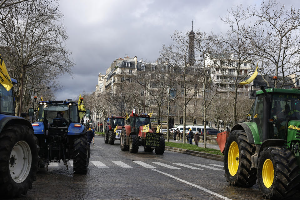 Farmers drive their tractors, Friday, Feb. 23, 2024 in Paris. Angry farmers were back to Paris on their tractors in a new protest demanding more government support and simpler regulations, on the eve of a major agricultural fair in the French capital. (AP Photo/Thomas Padilla)