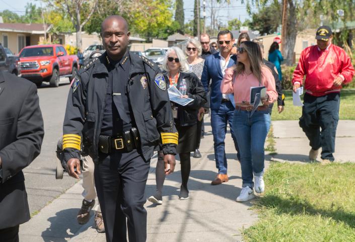 Stockton Police Chief Stanley McFadden, left, and other community leaders participate in neighborhood walk through in the Sierra Vista area of south Stockton. In March, the area experienced 2 double murders.