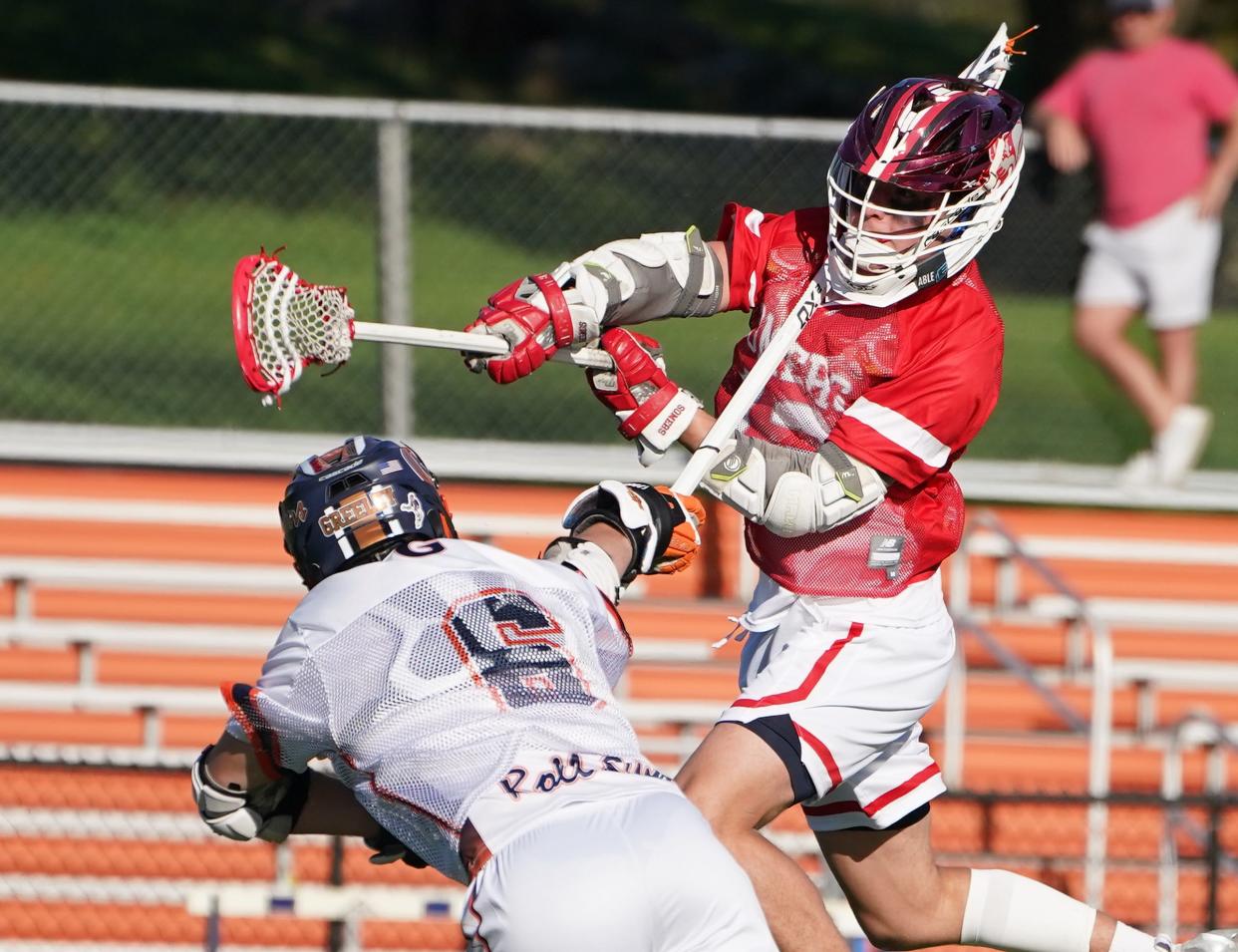 Somers' Ryan Brush (12) puts a shot over Horace Greely's Ryder Goodman (6) during their 15-6 win in boys lacrosse at Horace Greeley High School in Chappaqua. Thursday, May 2, 2024.