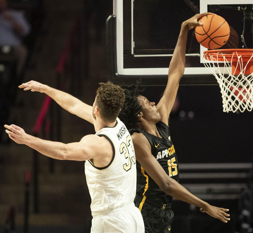 Appalachian State forward CJ Huntley (15) dunks over Wake Forest forward Matthew Marsh (33) in the first half of an NCAA college basketball game on Wednesday, Dec. 14, 2022, at Joel Coliseum in Winston-Salem, N.C. (Allison Lee Isley/The Winston-Salem Journal via AP)