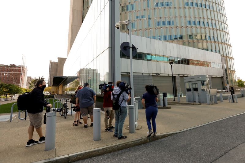 Press members wait outside the entrance of the federal court during the arraignment of Pascale Cecile Veronique Ferrier in Buffalo