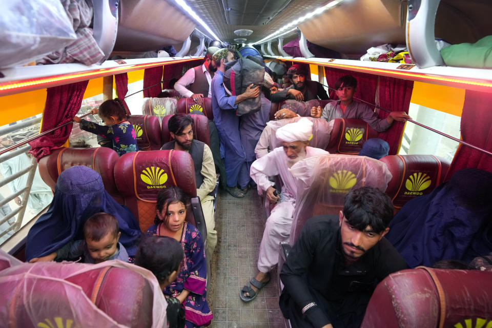 Afghan families board into a bus to depart for their homeland, in Karachi, Pakistan, Friday, Oct. 6, 2023. Pakistan's government announced a major crackdown Tuesday on migrants in the country illegally, saying it would expel them starting next month and raising alarm among foreigners without documentation who include an estimated 1.7 million Afghans. (AP Photo/Fareed Khan)