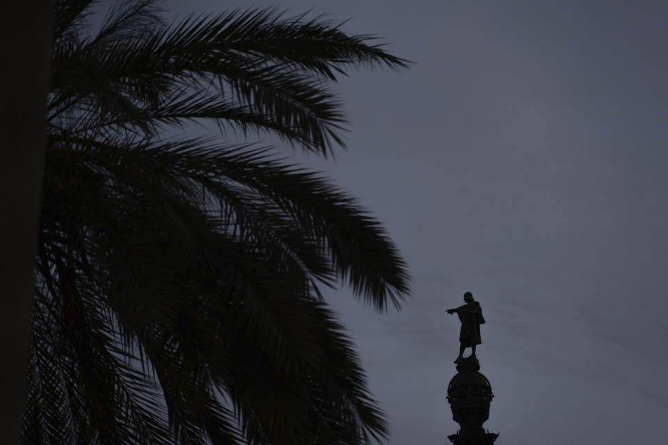 The statue of Christopher Columbus is seen as it points towards the sea in Barcelona, Spain, Thursday, July 2, 2020. Unlike in the United States, Britain and Belgium, statues of colonial-era figures have not become a major source of protests in Spain, which once ruled over one of the largest empires in history after conquering much of the Americas. Barcelona Mayor Ada Colau is one of the few public officials who say Spain must revisit its colonial legacy - though she is against timid calls to remove the city’s monument to Christopher Columbus. Instead, she tells The Associated Press that she encourages a public discussion about the Italian explorer whose landing in the Caribbean in 1492 gave birth to Spain’s overseas empire. (AP Photo/Renata Brito)