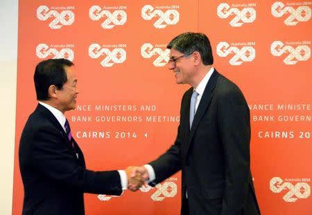 Japan's Finance Minister Taro Aso (L) and U.S. Treasury Secretary Jack Lew shake hands before the start of their bilateral meeting ahead of the G20 Finance Ministers and Central Bank Governors meeting in the northern Australian city of Cairns September 19, 2014. REUTERS/Lincoln Feast