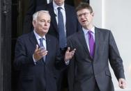 France's Foreign Minister Jean-Marc Ayrault (L) and Greg Clark Britain's Secretary of State for Business leave 10 Carlton House Terrace in central London, where representatives from Britain, China, France and energy company EDF signed an agreement to build and operate a new nuclear power station at Hinkley Point, Britain, September 29, 2016. REUTERS/Peter Nicholls