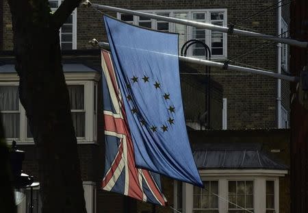 A British Union flag and a European Union flag hang from a building in central London, Britain February 18, 2016. REUTERS/Toby Melville