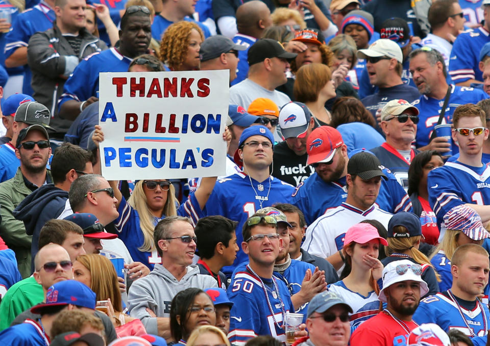 FILE - In this Sept. 14, 2014, file photo, a fan holds a sign thanking prospective Buffalo Bills owners Terry and Kim Pegula during the first half of an NFL football game between the Bills and the Miami Dolphins in Orchard Park, N.Y. The Pegulas took a step closer to buying the Bills after their NFL-record $1.4 billion purchase agreement was unanimously approved by the league's finance committee Wednesday, Sept. 17, 2014. (AP Photo/Bill Wippert, File)