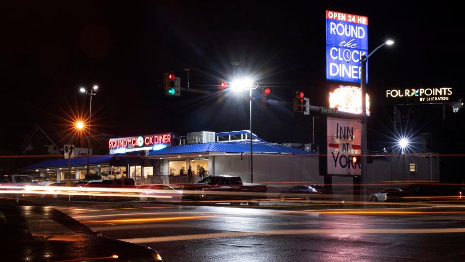 Customers come and go during a rainy night at the The Round the Clock Diner in Manchester Township July 19, 2023