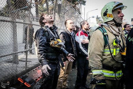 A man reacts at the site of a collapsed high-rise building in Tehran, Iran January 19, 2017. Tasnim News Agency/Handout via REUTERS