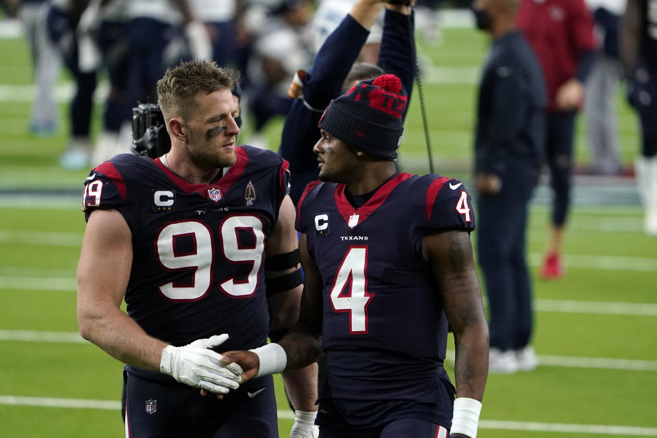 Houston Texans defensive end J.J. Watt (99) and quarterback Deshaun Watson (4) walk off the field after an NFL football game against the Tennessee Titans Sunday, Jan. 3, 2021, in Houston. The Titans won 41-38. (AP Photo/Eric Christian Smith)