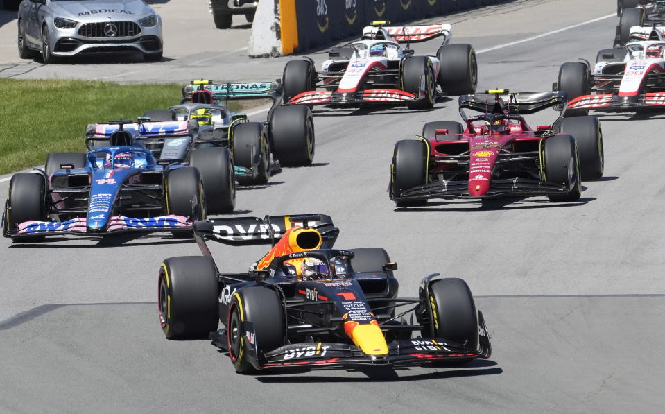 Red Bull Racing's Max Verstappen, of the Netherlands, leads the pack through the first turn at the start during the Canadian Grand Prix auto race Sunday, June 19, 2022 in Montreal. (Graham Hughes/The Canadian Press via AP)