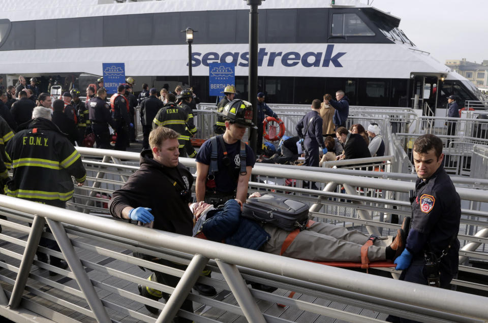 FILE - In this Jan. 9, 2013, file photo, New York City firefighters remove an injured passenger of the Seastreak Wall Street ferry in New York, after the ferry banged into the mooring as it arrived from New Jersey to the South Street in lower Manhattan during morning rush hour, injuring more than 80 people. The National Transportation Safety Board is scheduled to meet on Tuesday, April 8, 2014, to discuss the 2013 accident involving the high-speed passenger ferry. Four of the 331 people on board the vessel sustained serious injuries. (AP Photo/Mark Lennihan, File)