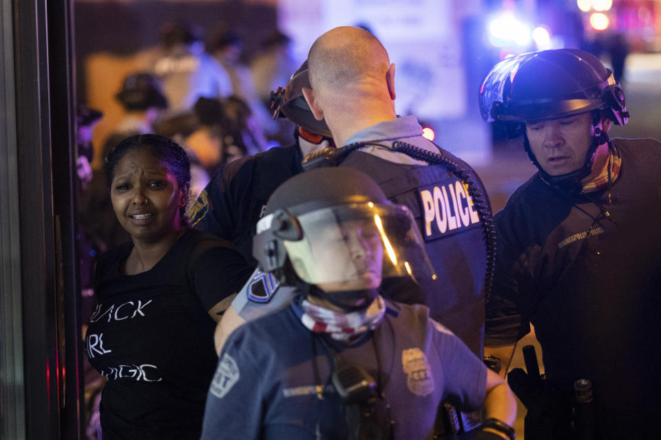 A protester is arrested by police after a vigil was held for Winston Boogie Smith Jr. early in Minneapolis on Saturday, June 5, 2021. Authorities said Friday that a man wanted on a weapons violation fired a gun before deputies fatally shot him in Minneapolis, a city on edge since George Floyd's death more than a year ago under an officer's knee and the more recent fatal police shooting of Daunte Wright in a nearby suburb. (AP Photo/Christian Monterrosa)