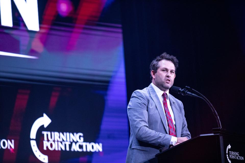 Turning Point Action's Chief Operating Officer Tyler Bowyer speaks on stage at the Unite and Win Rally in Phoenix on Aug. 14, 2022.
