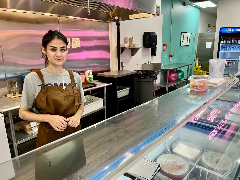 Meena Omar gets ready to wait on a customer behind the counter of the newly opened Famous Milkshake Bar in West Town Mall on Aug. 30, 2022.