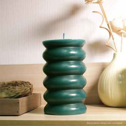 A scalloped pillar candle