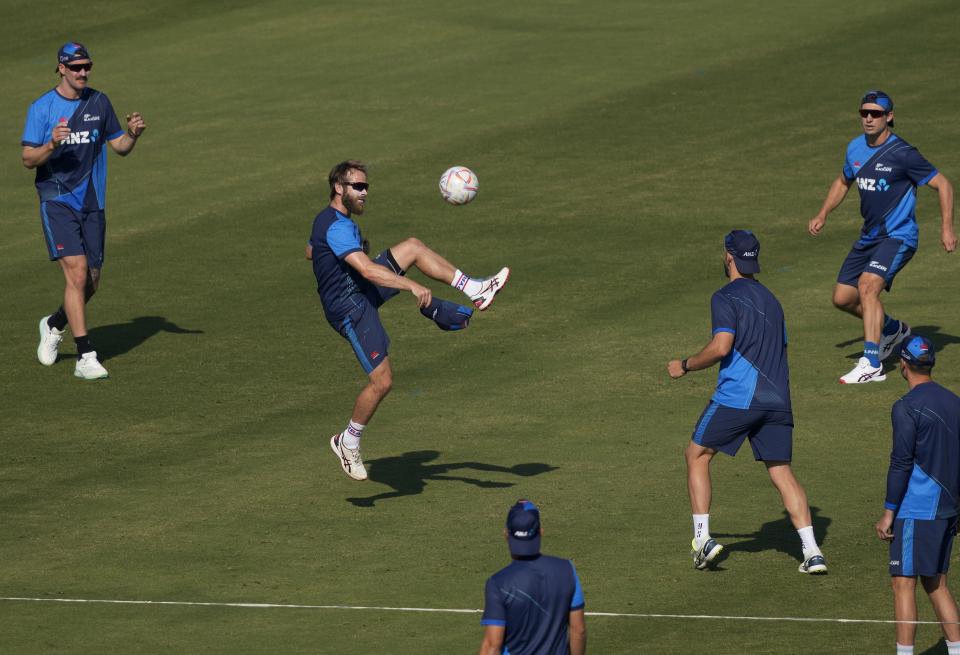 New Zealand's Kane Williamson, center, and teammates play with soccer ball during a training session, in Karachi, Pakistan, Friday, Dec. 23, 2022. (AP Photo/Fareed Khan)