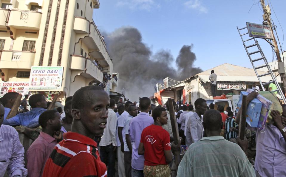 Somali traders watch as their stores burn, after a fire engulfed the Somali capital's main market in Mogadishu, Monday, Feb. 27, 2017. A police officer said the overnight inferno was moved by winds which started at the gold bazaar and rapidly spread into different areas of the market, razing large buildings, shops and food stores. (AP Photo/Farah Abdi Warsameh)