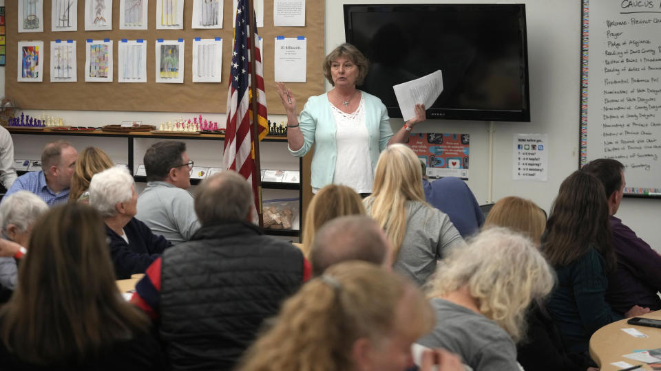 Cathy Boyd speaks during the Republican caucus at the Millcreek Junior High School on Tuesday, March 5, 2024, in Bountiful, Utah. Republican voters gathered at neighborhood precincts across Utah on Super Tuesday to select a presidential nominee through an in-person candidate preference poll. (AP Photo/Rick Bowmer)