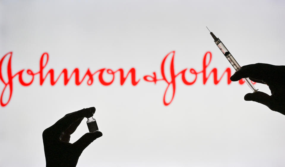 An illustrative image of a person holding a medical syringe and a Covid-19 vaccine vial in front of the the Johnson and Johnson logo displayed on a screen. 
On Wednesday, January 12, 2021, in Edmonton, Alberta, Canada. (Photo by Artur Widak/NurPhoto via Getty Images)