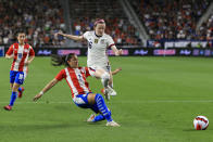 United States midfielder Rose Lavelle (16) leaps over United States defender Abby Dahlkemper (2) as she plays the ball during the first half of an international friendly soccer match, Tuesday, Sept. 21, 2021, in Cincinnati. (AP Photo/Aaron Doster)