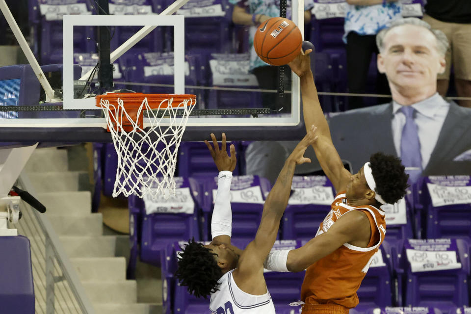 Texas forward Kai Jones (22) scores in front of TCU guard RJ Nembhard (22) during the second half of an NCAA college basketball game in Fort Worth, Texas, Sunday, March 7, 2021. (AP Photo/Michael Ainsworth)