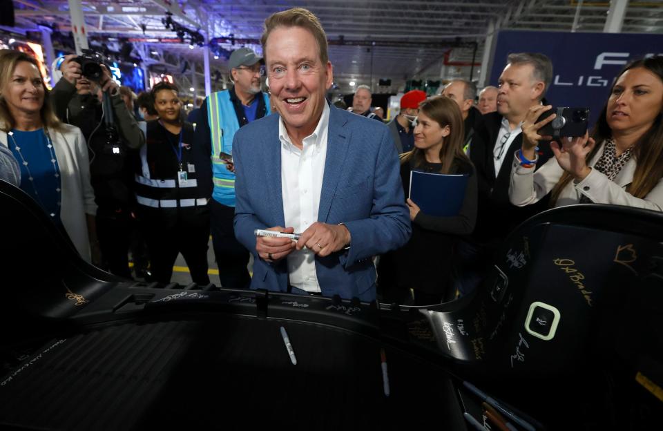 Bill Ford, executive chair of Ford Motor Co., is all smiles after adding his signature to the trunk of a Ford F-150 Lightning at Ford Rouge Electric Vehicle Center, before the official launch of the F-150 Lightning pickup truck at the plant in Dearborn on Tuesday, April 26, 2022.