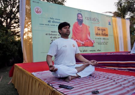 A man performs yoga during a yoga camp organised by Patanjali in Ahmedabad