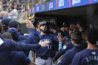 Seattle Mariners' Mitch Haniger (17) celebrates in the dugout after hitting a solo home run during the second inning of a baseball game against the Minnesota Twins, Tuesday, May 7, 2024, in Minneapolis. (AP Photo/Abbie Parr)