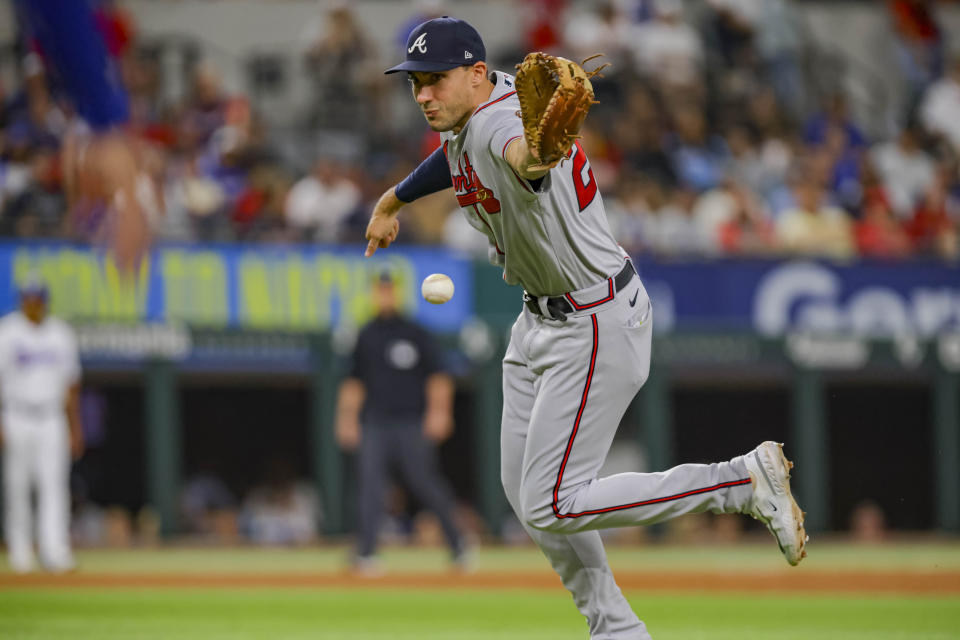 Atlanta Braves first baseman Matt Olson flips the ball to pitcher Charlie Morton in the bottom of the first inning of a baseball game against the Texas Rangers in Arlington, Texas, Monday, May 15, 2023. (AP Photo/Gareth Patterson)