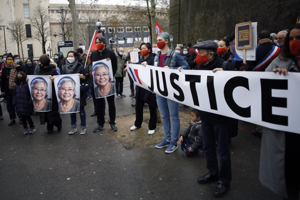 Activists hold pictures of Tran To Nga, a 78-year-old former journalist, during a gathering in support of people exposed to Agent Orange during the Vietnam War, in Paris, Saturday Jan. 30, 2021. Activists gathered Saturday in Paris in support of people exposed to Agent Orange during the Vietnam War, after a French court examined a case opposing a French-Vietnamese woman to 14 companies that produced and sold the toxic chemical. (AP Photo/Thibault Camus)