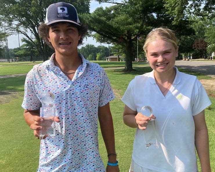 Laird Williams, left, and Ainsley Moore show off their Tennessean/Metro Parks Schooldays golf tournament trophies, which they won Friday at McCabe Course.