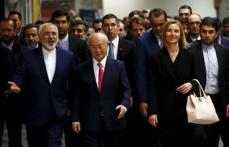 Iranian Foreign Minister Javad Zarif, International Atomic Energy Agency (IAEA) Director General Yukiya Amano and the High Representative of the European Union for Foreign Affairs and Security Policy Federica Mogherini (front L-R) arrive at the United Nations building in Vienna, Austria, January 16, 2016. REUTERS/Leonhard Foeger