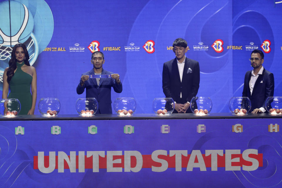 Filipino FIBA ambassador LA Tenorio, second from left, shows the number for USA national basketball team during the FIBA World Cup draw 2023 in Quezon city, Philippines on Saturday April 29, 2023. (AP Photo/Josefino de Guzman)