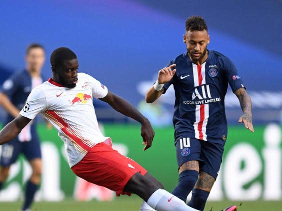 Leipzig’s Dayot Upamecano (L) fights for the ball with Paris Saint-Germain’s Neymar (POOL/AFP via Getty Images)