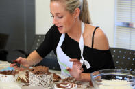 <p>Reeva Steenkamp with the cake she baked at the BBC Lifestyle launch of 'Bake-Off' (Gallo Images / Rex Features)</p>