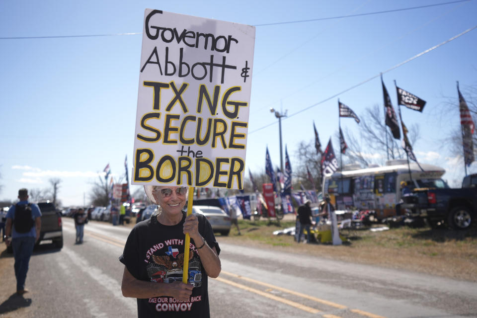 A participant carries a sign outside of a "Take Our Border Back" rally, Saturday, Feb. 3, 2024, in Quemado, Texas. (AP Photo/Eric Gay)