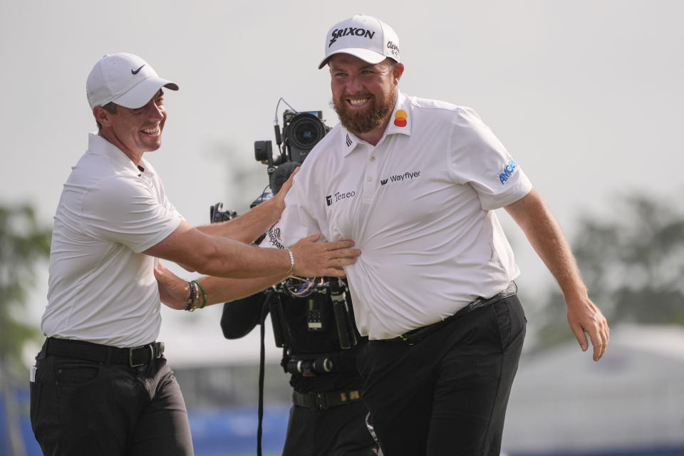 Shane Lowry, of Ireland, right, embraces his teammate Rory McIlroy, of Northern Ireland, after winning the PGA Zurich Classic golf tournament at TPC Louisiana in Avondale, La., Sunday, April 28, 2024. (AP Photo/Gerald Herbert)