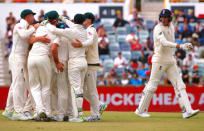 Cricket - Ashes test match - Australia v England - WACA Ground, Perth, Australia, December 18, 2017. England's Craig Overton reacts as he walks past Australia's Josh Hazlewood celebrating with team mates after his dismissal during the fifth day of the third Ashes cricket test match. REUTERS/David Gray