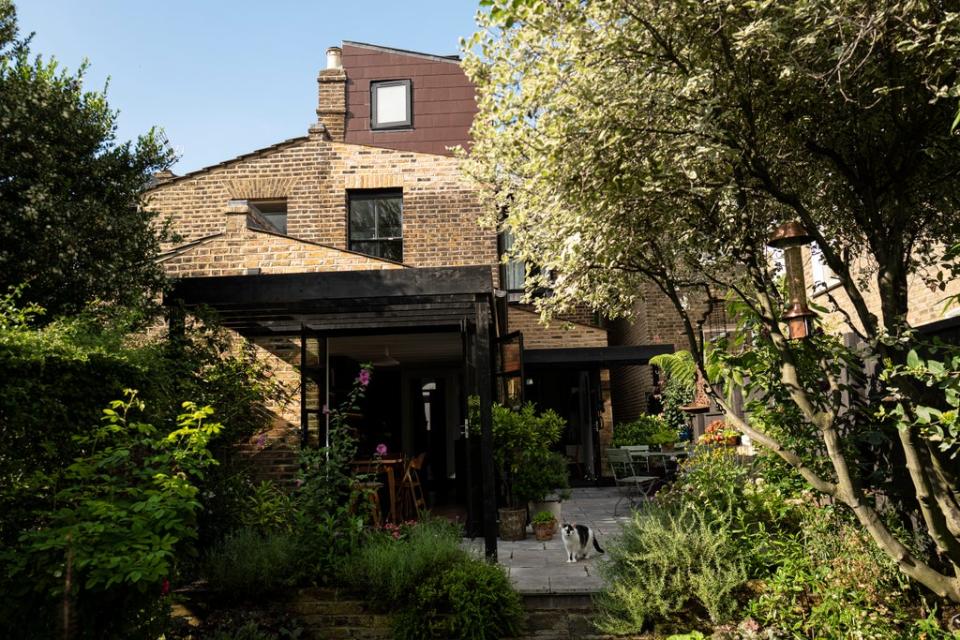 The new second-floor bathroom can be seen from the garden above the stylish extended canopy (Daniel Hambury/Stella Pictures Ltd)