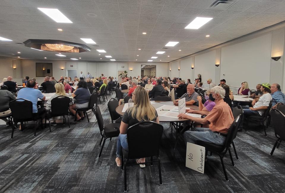 Area residents watch during a presentation about the Marine City Highway corridor plan on Wednesday, June 29, 2022, at the Harvest Event Center.