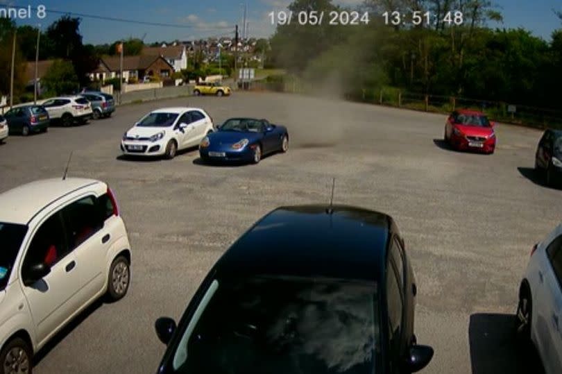 The whirlwind passed over the blue open-top car seen in the picture and set off its alarm