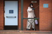 A man disinfects public toilets in Leicester, England, Monday June 29, 2020. The British government is reimposing lockdown restrictions in the central England city of Leicester after a spike in coronavirus infections, including the closure of shops that don’t sell essential goods and schools. (Joe Giddens/PA via AP)