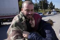 A Syrian couple mourns the loss of their daughter, as her body is transferred to Syria, from the Turkish crossing point of Cilvegozu, in Reyhanli, southeastern Turkey, Thursday, Feb. 9, 2023. Rescuers pulled more survivors from beneath the rubble of collapsed buildings Thursday, but hopes were starting to fade for finding many more people alive more than three days after a catastrophic earthquake and series of aftershocks hit Turkey and Syria. (AP Photo/Hussein Malla)