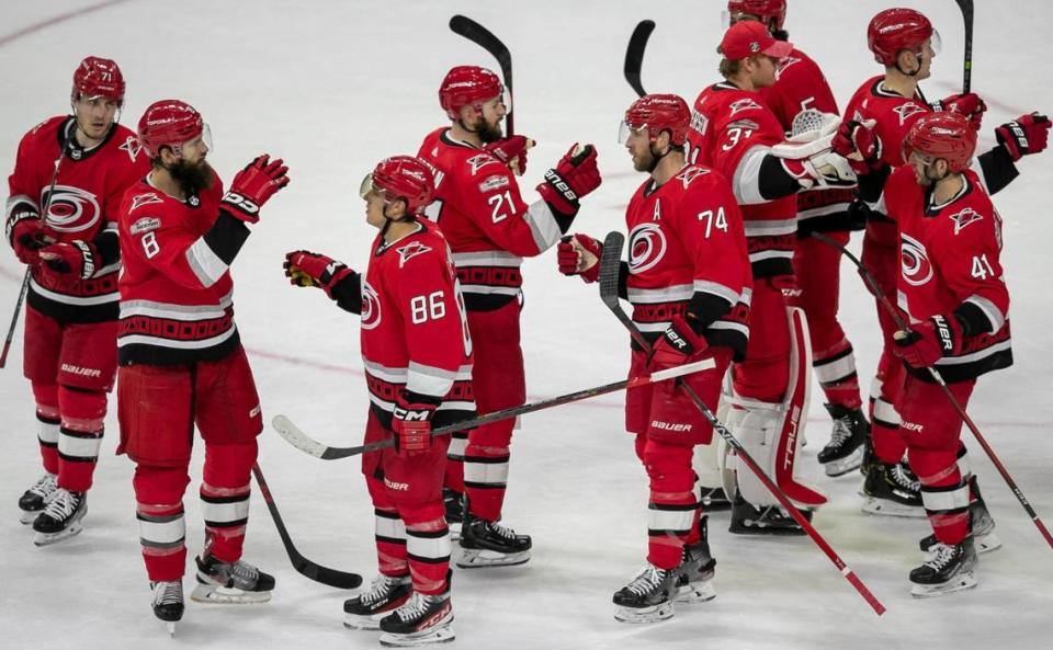 Carolina’s Hurricanes players Teuvo Teravainen (86) and Jaccob Slavin (74) celebrate the Hurricanes’ 2-1 victory over the New York Islanders with teammates on Tuesday, April 17, 2023 at PNC Arena in Raleigh, N.C.