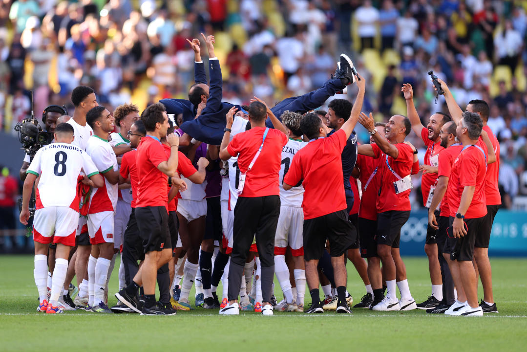 NANTES, FRANCE - AUGUST 08: Players of Team Morocco celebrate victory with Tarik Sektioui, Head Coach of Team Morocco after the Men's Bronze Medal match between Egypt and Morocco during Day Thirteen of the Olympic Games Paris 2024 at Stade de la Beaujoire on August 08, 2024 in Nantes, France. (Photo by Robert Cianflone/Getty Images)