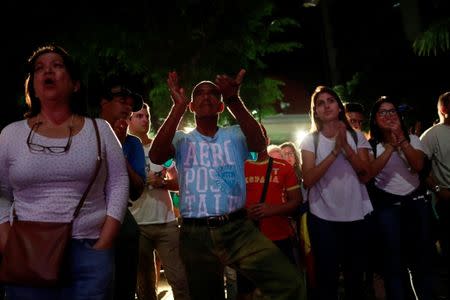 Opposition supporters react while waiting for results of the unofficial plebiscite against President Nicolas Maduro's government and his plan to rewrite the constitution, in Caracas, Venezuela July 16, 2017. REUTERS/Marco Bello