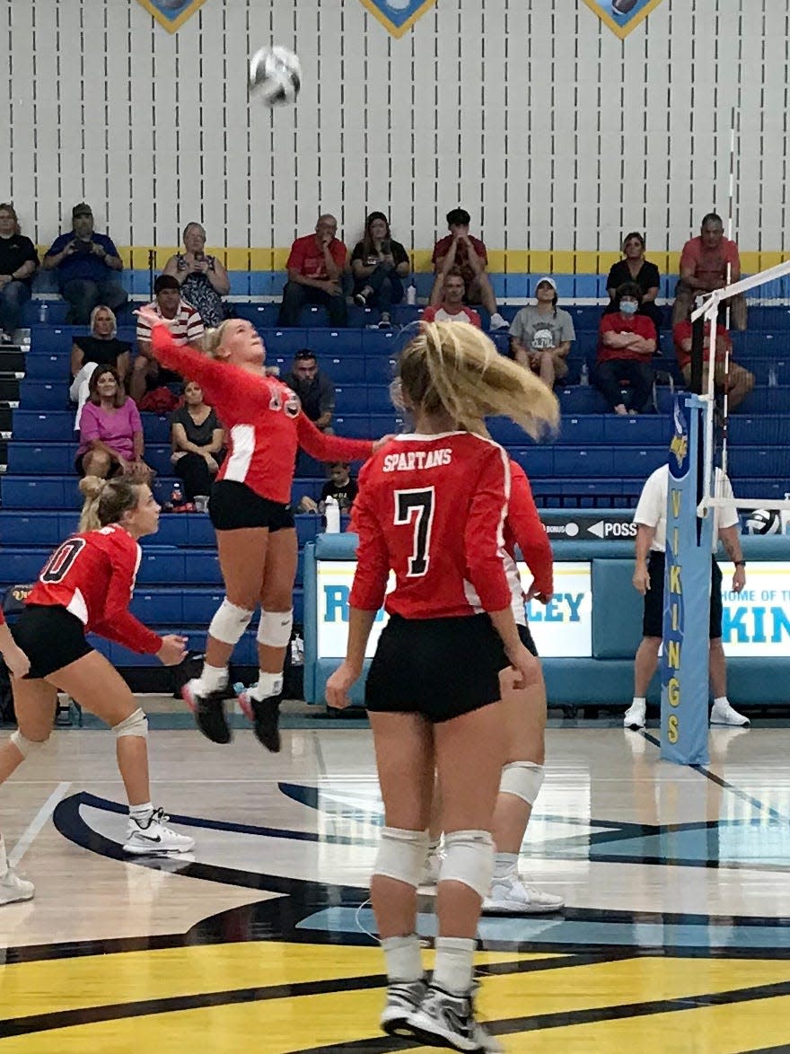 Pleasant's Lexi Olt goes up for a kill during a volleyball match at River Valley last year.