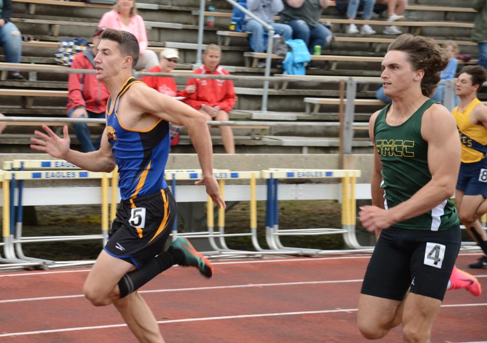 Carsten Kirby of Ida (left) and St. Mary Catholic Central's Cole Jondro battle for the lead in the boys 100 meters at the 58th annual Mason Invitational Saturday.