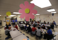 Migrant teens eat lunch at a "tender-age" facility for babies, children and teens, in Texas' Rio Grande Valley, Thursday, Aug. 29, 2019, in San Benito, Texas. The facility offers services that include education, nutrition, hygiene, recreation, entertainment, medical, mental health and counseling, according to a U.S. Health and Human Services official. (AP Photo/Eric Gay)